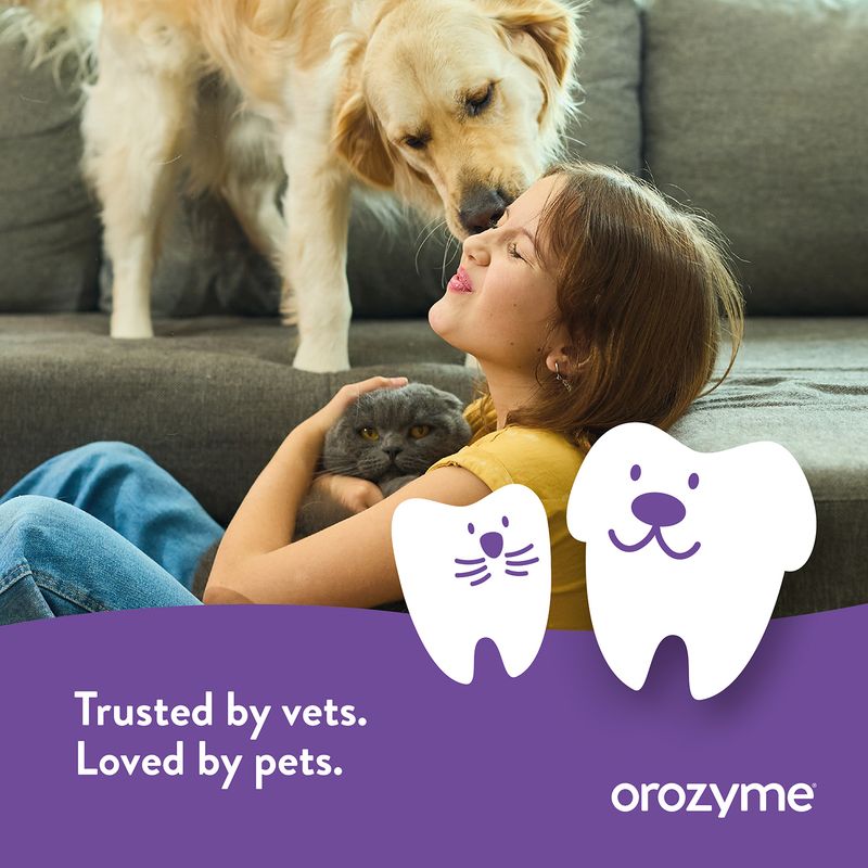 Girl with dog and cat on sofa, Text: Trusted by vets. Loved by pets. orozymes.