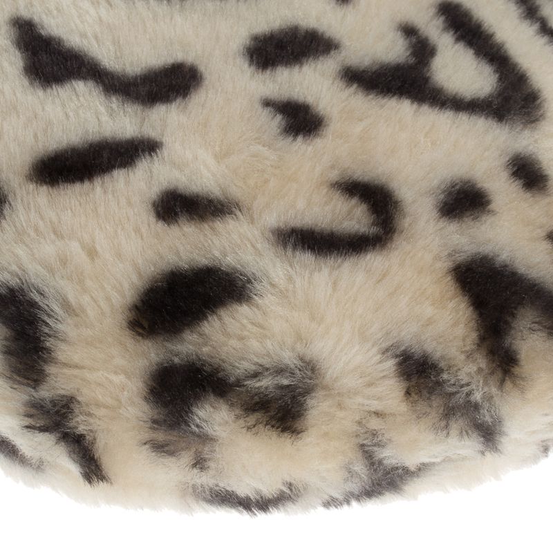 Close-up of a soft beige fabric with a black leopard pattern.