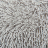Close-up of grey, fluffy material with long fibres, possibly suitable for pet beds or blankets.