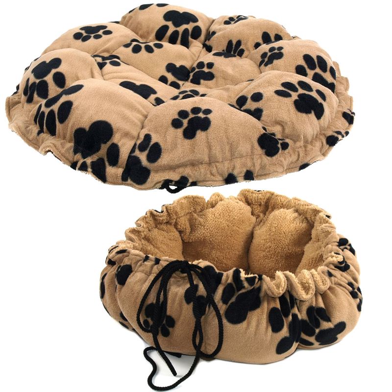 Image shows a round, beige mat with black paw prints that can be used flat or drawn up into a soft nest shape using drawstrings.