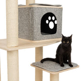 Cat tree with sisal posts, grey cave with paw motif and padded lying surface. Black cat sitting on the lower platform.
