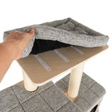 Hand showing removable, padded cushion with hook-and-loop fasteners on a wooden platform of a cat tree.