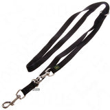 Black nylon dog lead with metal carabiner and D-ring, green logo label visible.
