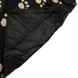 Black car seat cover with beige paw pattern, durable material and adjustable straps for secure fit.