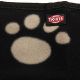 Trixie logo on black fabric with beige paw print pattern.