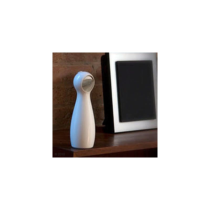 White, modern device with a round head on a wooden table, possibly a household appliance or decorative object.