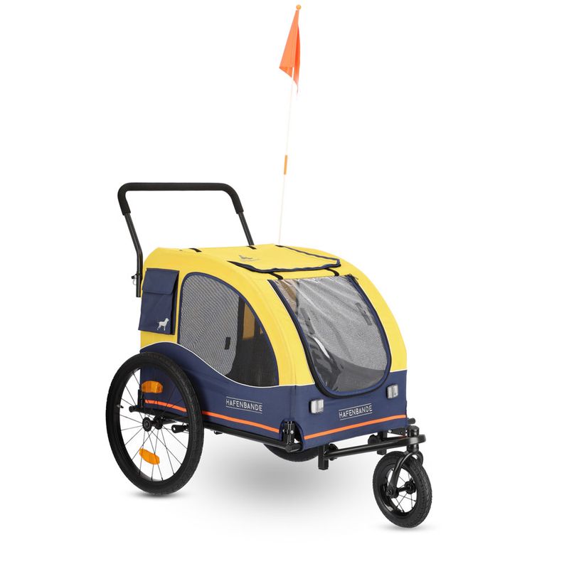 Yellow and blue dog trailer with three wheels, mesh windows, orange safety flag and the inscription 'Hafenbande'.