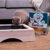 Sanicat Active Gold cat litter with Oxygen Odour Control, 6L pack. Cat inspecting a wooden litter box next to the packaging.