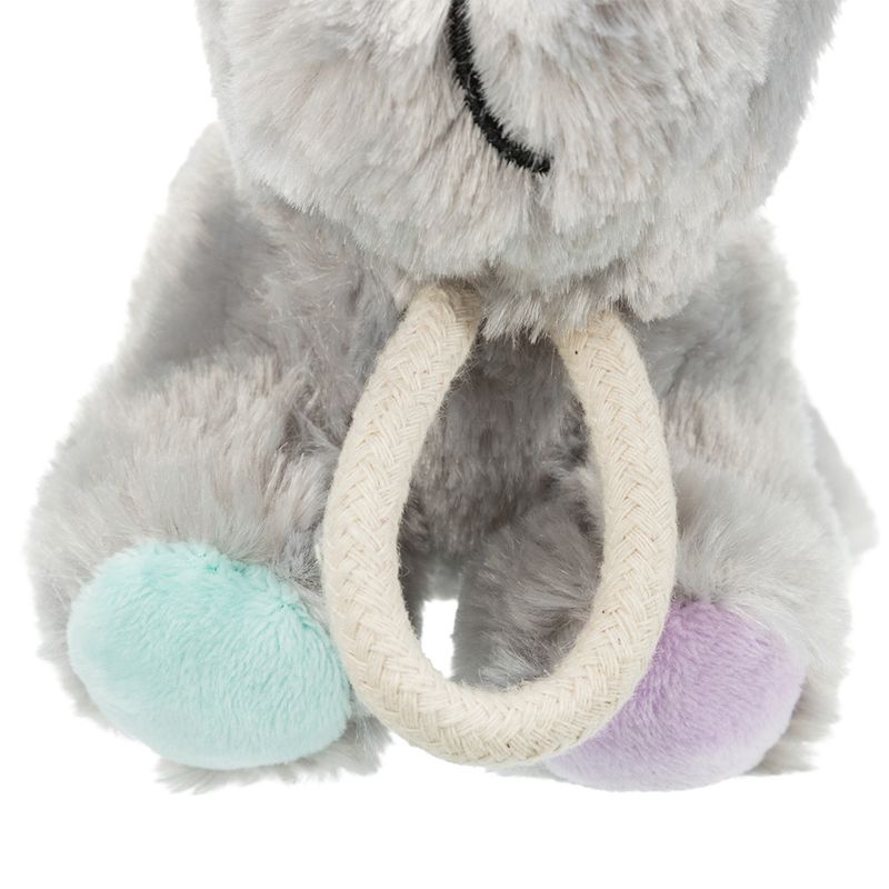 Grey plush toy with a mint green and purple paw and a white rope ring as a handle.