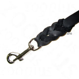 Close-up of a braided black leather lead with a metal clip attachment, showing connection detail for securing to a collar or harness.