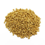 Close-up of yellowish-brown granules, possibly pet food or litter.