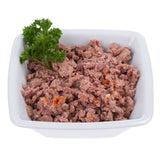 Bowl with shredded wet food, visible meat pieces and carrots, garnished with fresh parsley.