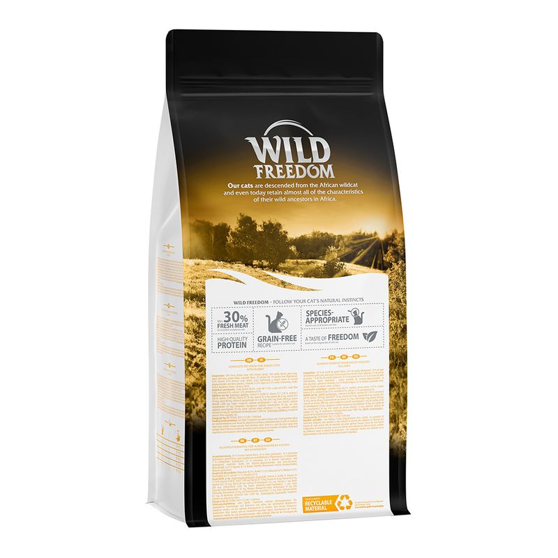 Wild Freedom cat food, 30% fresh meat, grain-free, species-appropriate, recyclable material. Description and ingredients visible on packaging.