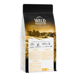 Wild Freedom cat food, 30% fresh meat, grain-free, species-appropriate, recyclable material. Description and ingredients visible on packaging.