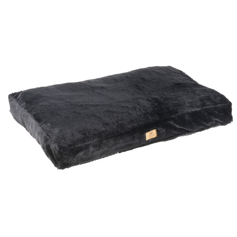 Black rectangular cushion with soft plush cover and small brand label on the side.