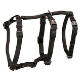 Black adjustable harness with buckles and metal ring, suitable for pets. Trixie brand visible on the buckles.