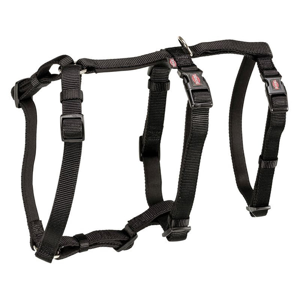 Black adjustable harness with buckles and metal ring, suitable for pets. Trixie brand visible on the buckles.