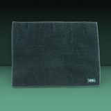 Dark green mat with microfibre texture, rectangular, 'kooa' brand logo visible at bottom right.