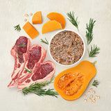 Ingredients: raw meat, pumpkin pieces, rosemary sprigs and bowl with crushed food. Depiction of the product’s natural ingredients.