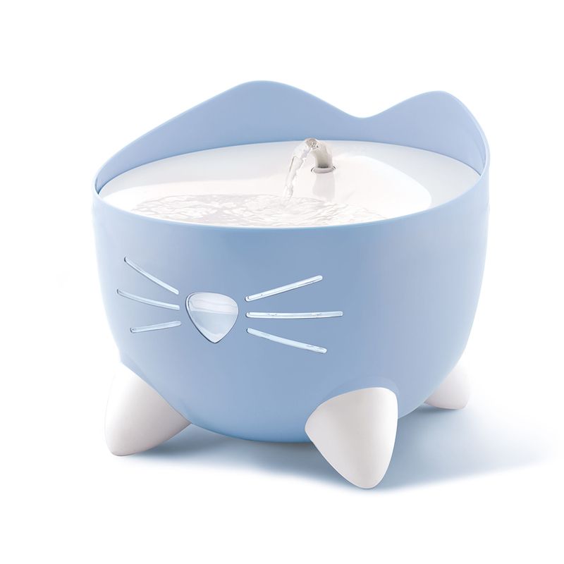 Blue drinking fountain in the shape of a cat with flowing water and white paws as feet.