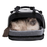 Transport bag with soft grey lying surface and a cat inside. Bag with carrying handles and zip opening.