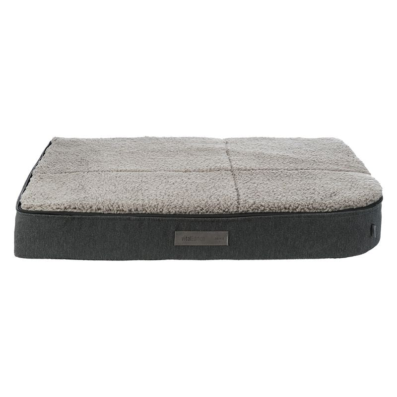 Vital Edition dog bed with grey fabric cover and soft beige plush lying surface. Rectangular shape with label on the side.