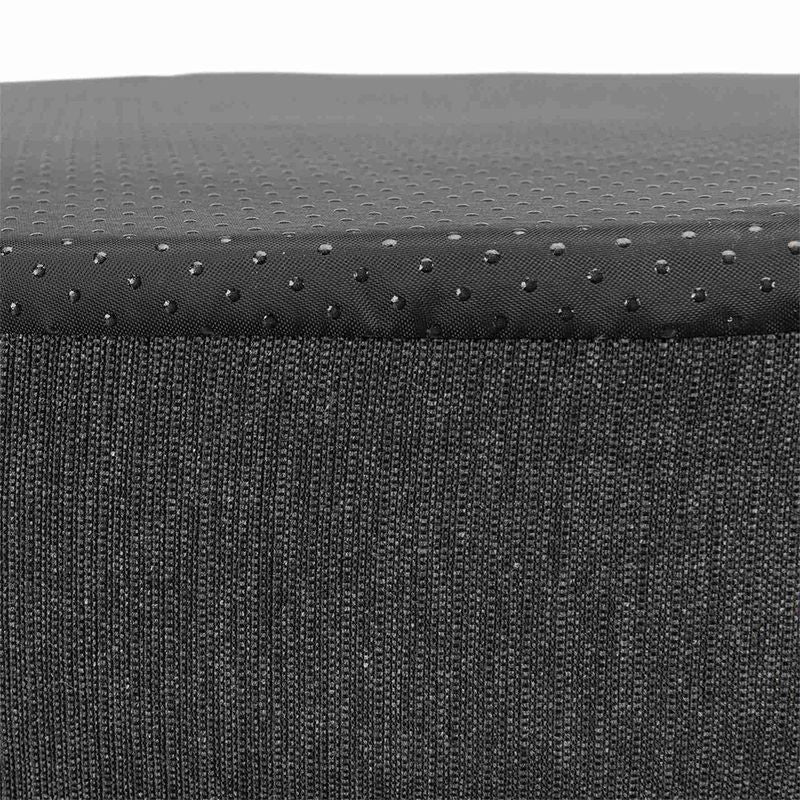 Close-up of black fabric material with non-slip surface and dotted texture.