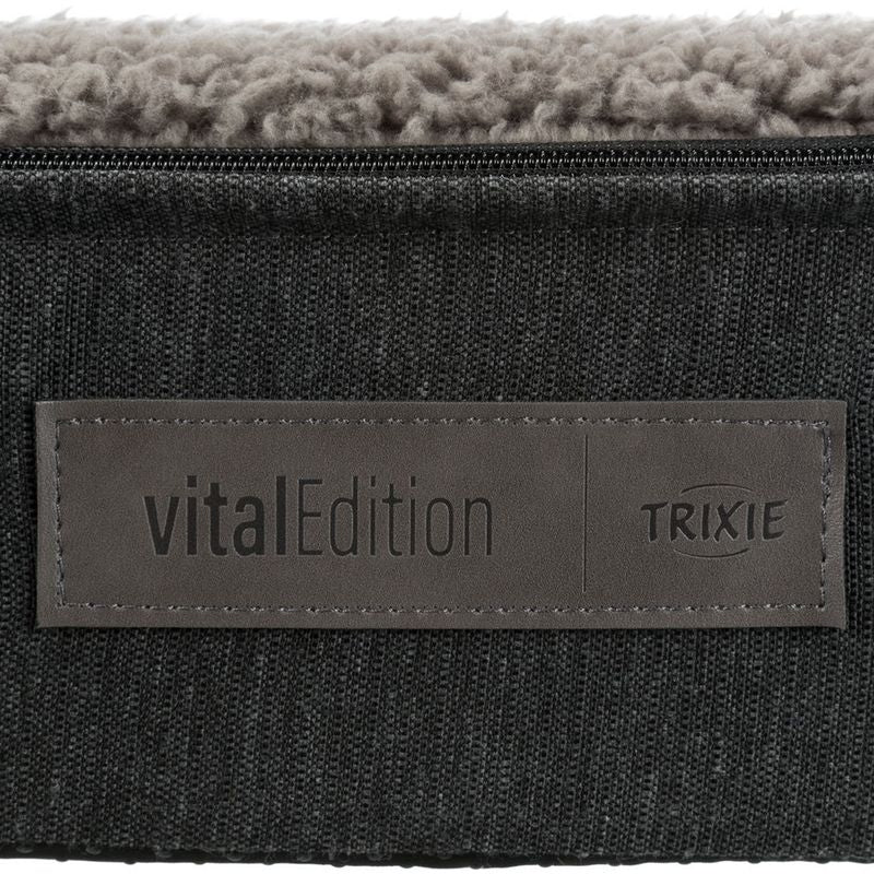 vitalEdition Trixie. Product label on grey fabric with faux leather appliqué.