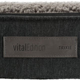 vitalEdition Trixie. Product label on grey fabric with faux leather appliqué.