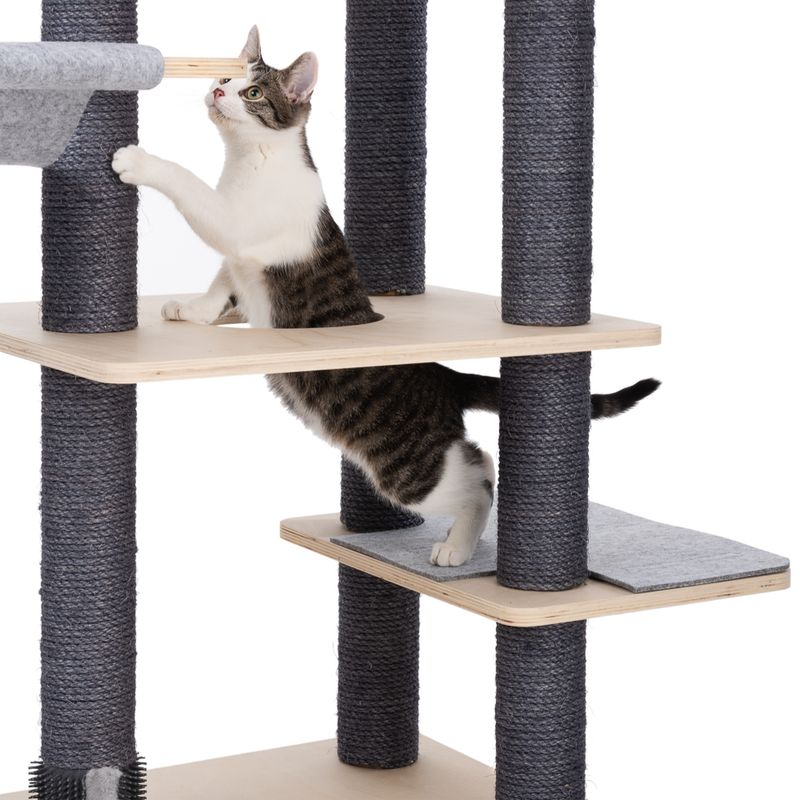 Cat tree with multiple levels, wooden and sisal-wrapped posts, cat playing on the middle level.