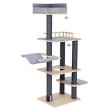 Cat tree with multiple levels, sisal-wrapped posts, grey resting surfaces and cave, toy balls on strings, wooden frame and brush at the base.