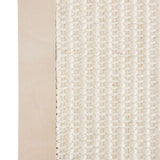Close-up of a scratch board material with a light wood frame and white sisal fabric.