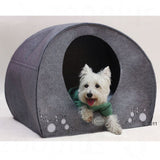 Grey felt pet house with round opening and decorative circles, suitable as a retreat for small animals.