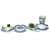 Interactive toy with multiple stations: brush, food dispenser, grass area and puzzle elements. Encourages activity and engagement.