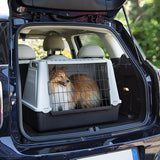 Plastic transport box with metal grid, placed in a car boot. Suitable for safe animal transport.