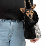 Carrier bag with black and white pattern and black plush lining, suitable for small pets. Gold chains visible as carrying handle.