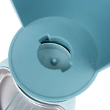 Close-up of a blue food dispenser with an opening for dispensing pet food.