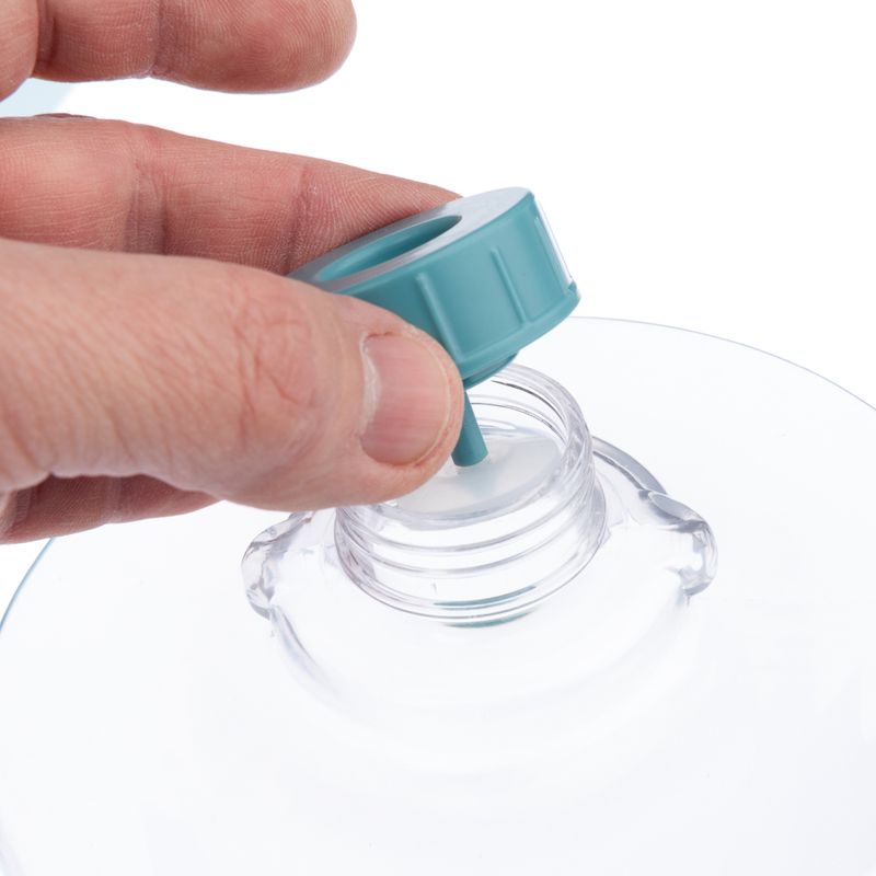 Hand showing how a turquoise lid is screwed onto a transparent bottle.