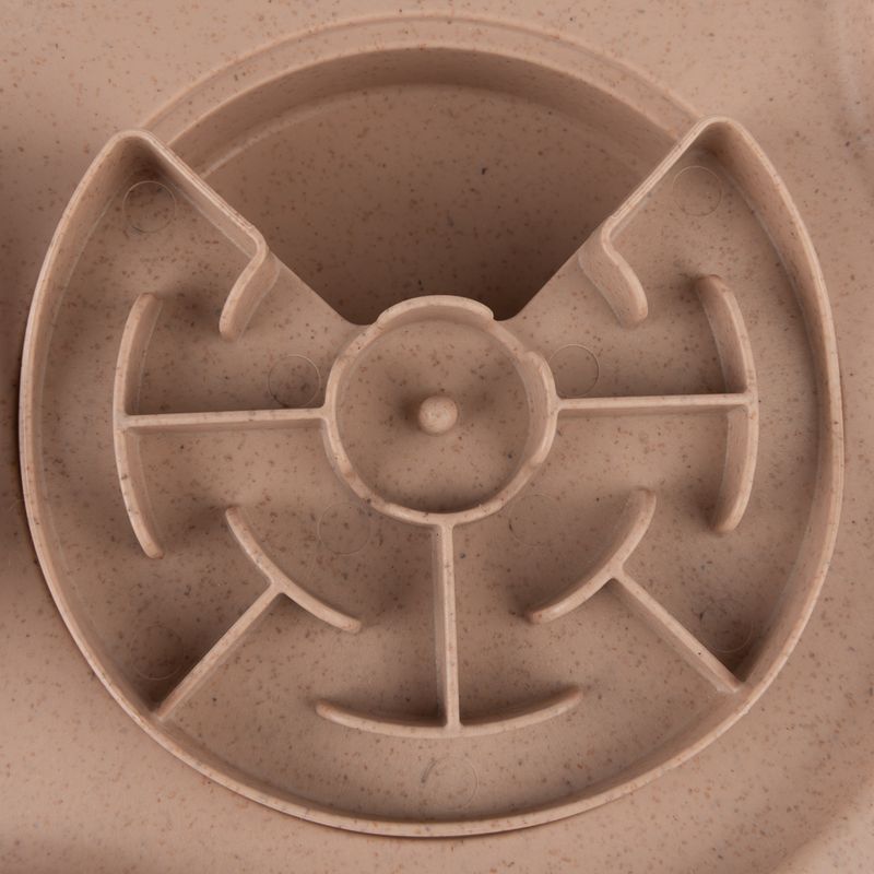 Round feeding maze made of beige plastic with several partitions for slow feeding.