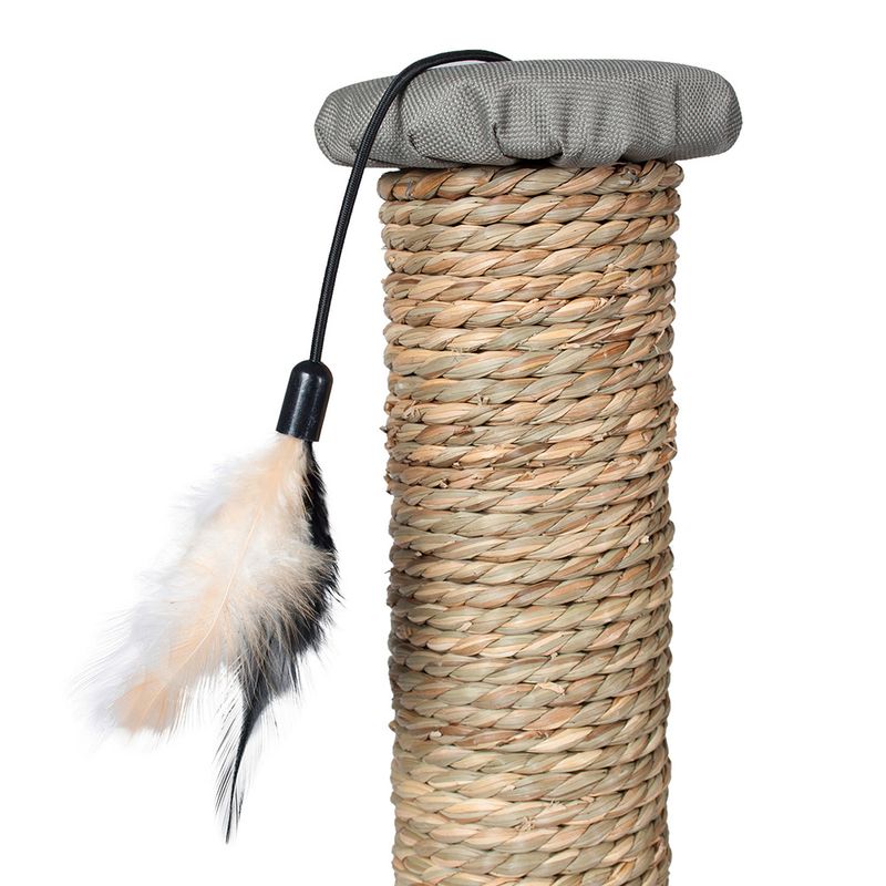 Scratching post made of braided natural material with grey cushion on top and toy with feathers on a string.