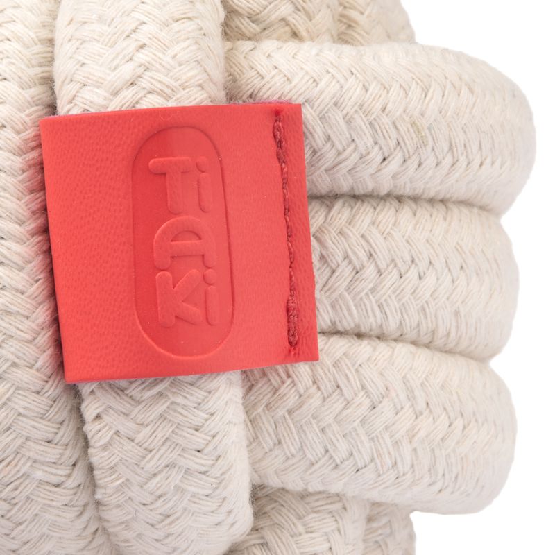 Tiaki logo on a red label attached to a cream-coloured braided rope.