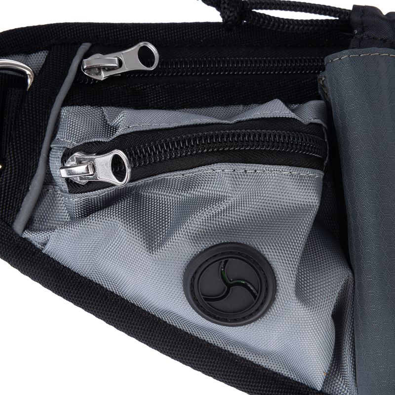 Close-up of a grey bag with two zips and a round black ventilation element.