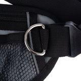 Close-up of a black harness with mesh material, adjustable strap and metal D-ring for attachment.