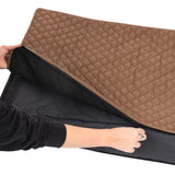 Brown, quilted dog mat with black underside and zip. Hand shows opening the cover.