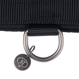 Close-up of a black nylon collar with metal D-ring and pendant with 'NT' logo.
