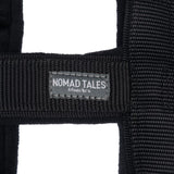 Nomad Tales München. Black textile collar with visible brand label.