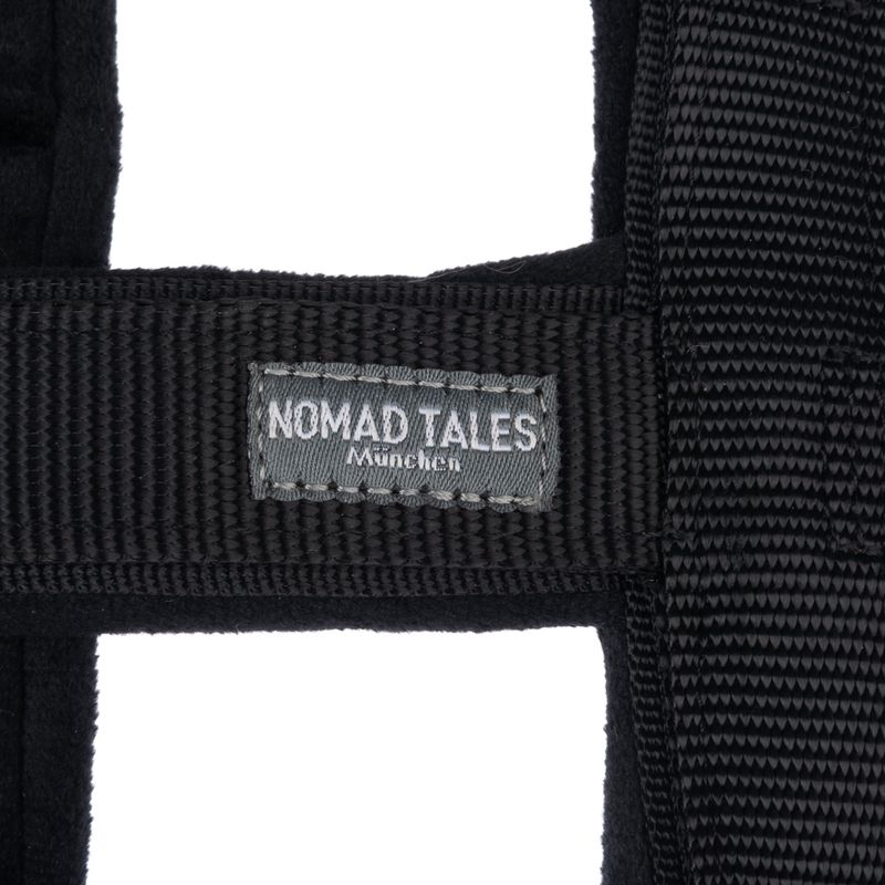 Nomad Tales München. Black textile collar with visible brand label.