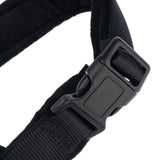 Close-up of a black plastic click fastener on a nylon strap.