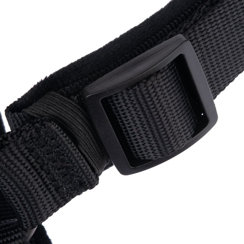 Close-up of a black strap with plastic buckle and woven material.