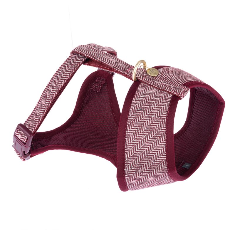 Red dog harness with herringbone pattern, padded inner material and adjustable straps. Metal ring for leash attachment visible.